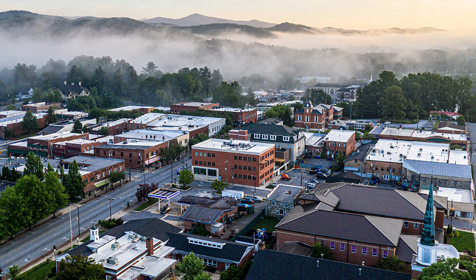 Downtown Brevard beneath misty, forested Blue Ridge foothills