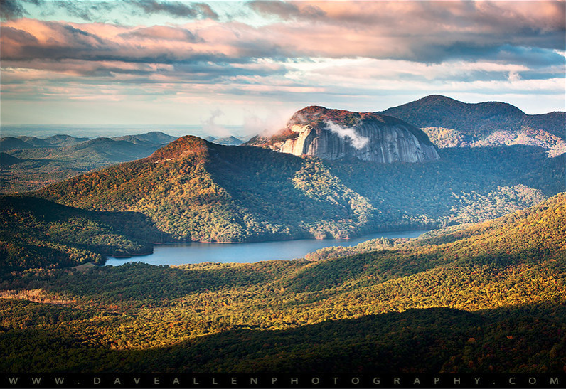 Table Rock above a lake and autumn-colored forest beneath a dramatic sky